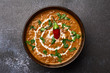Dal Makhani at dark background. Dal Makhani - traditional indian cuisine puree dish with urad beans, red beans, butter, spices and cream.