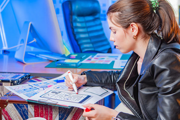 Poster - the designer develops new applications for mobile devices. the girl makes notes on the scheme of the