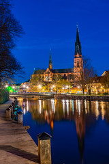 Sticker - Sunset view of Uppsala cathedral reflecting on river Fyris in Sweden