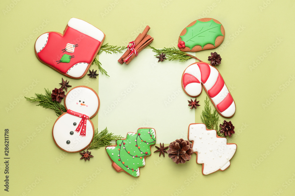 Composition with tasty Christmas cookies and paper on color background