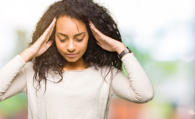 Poster - Young beautiful girl with curly hair wearing casual sweater with hand on head for pain in head because stress. Suffering migraine.