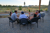 Fototapeta Uliczki - Six friends around a fire pit enjoy afternoon view of landscape around Sisters, Oregon on a perfect summer afternoon.