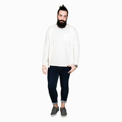 Wall Mural - Young man with long hair and beard wearing sporty sweatshirt depressed and worry for distress, crying angry and afraid. Sad expression.