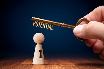 Wall Mural - Coach has a key to unlock potential - motivation concept. Coach (manager, mentor, HR specialist) unlock leader potential and talent represented by wooden figurine and hand with key.