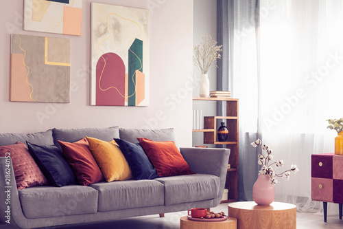 Yellow Orange Black And Brown Pillows On Comfortable Grey