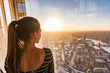 Europe travel woman tourist looking at London city skyline from The Shard tower, touristic attraction in the U.K. Girl enjoying sunset view.