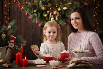 Wall Mural - Mother and little girl with christmas cookies  at home