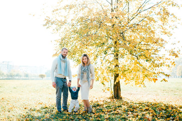 Wall Mural - Family couple posing outdoor with their beautiful baby.