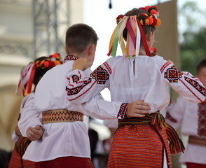 Young dancers in traditional folk Ukrainian costumes during their show on stage