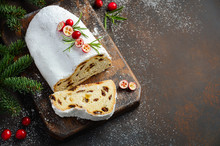 Christmas Stollen. Traditional German, European Festive Dessert. Holiday Concept Decorated With Fir Branches And Cranberries.