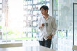© Kris Tan - Portrait of casual young  entrepreneur businessman working in modern work station.