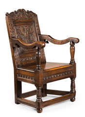 Old antique oak wainscot chair with carving isolated on white