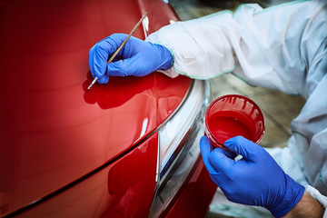 Wall Mural - Tinting defects of a red car paint on the service