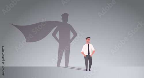 Fotomural businessman dreaming about being super hero shadow of man with cape imagination