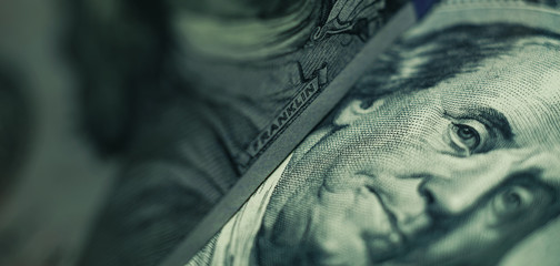 close up franklin's face on a one hundred dollar. american, us dollars cash money background.