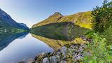 Fototapeta Do pokoju - Moutains reflecting in the water of lake Eidsvatnet in Eidsdal along national scenic road 63, Trondelag county in Norway