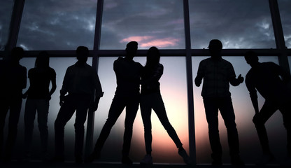 Wall Mural - group of young people in the background of a large window