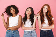 © Drobot Dean - Thinking thoughtful young three multiethnic girls friends posing isolated over pink wall background.