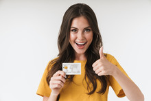 Image Of Gorgeous Brunette Woman Wearing Casual Clothes Showing Thumb Up And Holding Credit Card