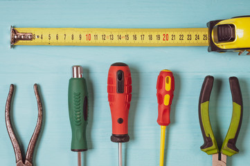 tools close-up top view, tape measure, screwdriver, pliers