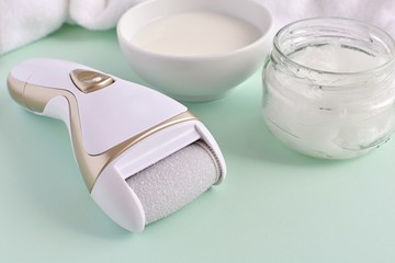 Electric foot file and natural products for feet care milk and coconut oil for softer skin