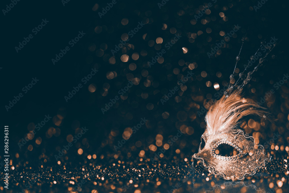 Luxury venetian mask on dark godlen bokeh background. New year and christmas party celebration design banner. - obrazy, fototapety, plakaty 