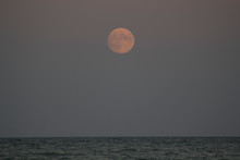 The Red Full Moon Over The Sea