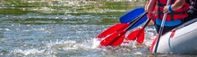 Rafting Trip. Close Up View Of Oars With Splashes Of Water. Rowers Make An Effort To Overcome The Turbulent River. The Concept Of Teamwork, Healthy Lifestyle.