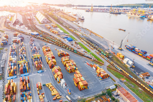 Fotografía Panoramic aerial top view from the heights of the cityscape port harbor and industrial area, container warehouse and railway system network leading to the seaport