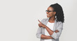 © Prostock-studio - Smiling Black Businesswoman Pointing Finger At Copy Space, White Background