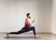 © junky_jess - Warrior pose. Caucasian fit man stands in deep stretching and doing yoga in fitness studio, side view, selective focus.