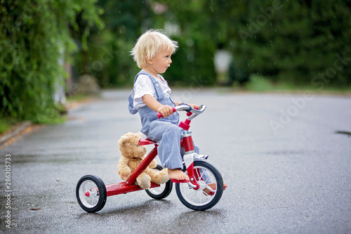 boy riding tricycle