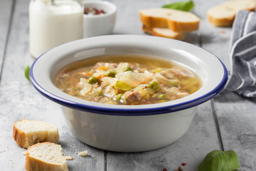 Canvas Print - Vegetable soup with cabbage, meat, potatoes, zucchini, carrots, green peas, sour cream and bread. Delicious lunch, traditional first course, Russian