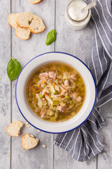 Canvas Print - Vegetable soup with cabbage, meat, potatoes, zucchini, carrots, green peas, sour cream and bread. Delicious lunch, traditional first course, Russian