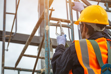 [safety Body Construction] Working At Height Equipment. Fall Arrestor Device For Worker With Hooks For Safety Body Harness On Selective Focus. Worker As In Construction Background.