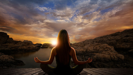 Wall Mural - Woman in yoga pose in front of the sea
