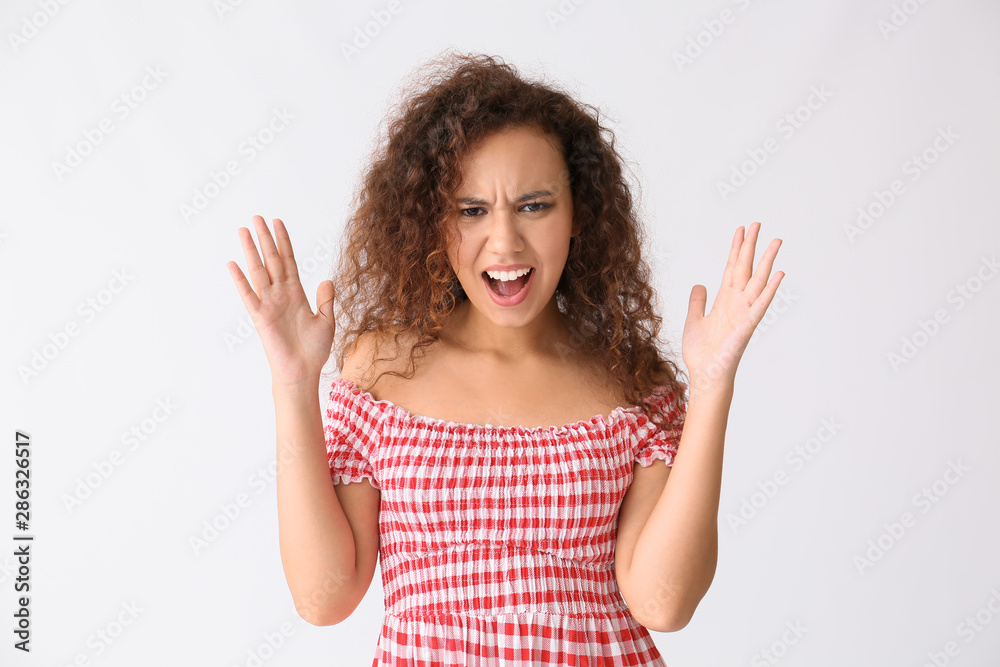 Stressed African-American woman on white background