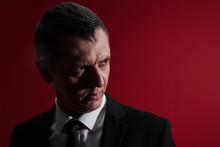 The Evil Boss. Portrait Of An Angry Man In A Business Suit With Red Eyes With Rage. Aggressive Person