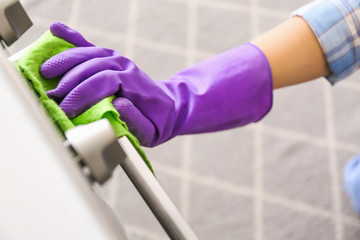 Woman cleaning oven in kitchen, closeup