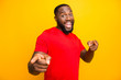 © deagreez - Photo of excited black man pointing at you with two forefingers while isolated with yellow background