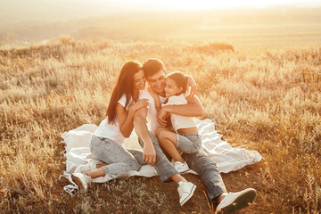 Lovely family cuddling on countryside