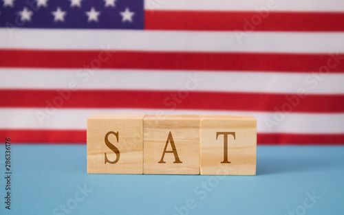 Fotografía SAT Exam in WOoden blook letters on US flag