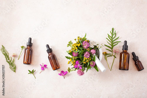Fotomural medical flowers herbs in mortar essential oils in bottles