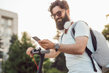 Smiling Hipster Using Modern Gadgets In Everyday Life