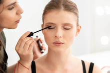 Make Up Artist Applies Mascara. Hand Of Make-up Master, Painting Model Eyes