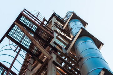 high technical structure with a pipe against the blue sky