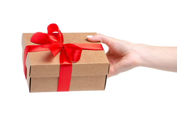 Box with red ribbon bow gift in hand on white background isolation