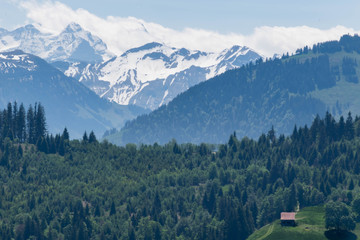 Wall Mural - Scenic view on single house in the Alps mountains, Switzerland