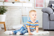 © 5second - Little boy sitting on white carpet at home