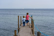 © FrankW - Two children go hand in hand over a footbridge by the sea